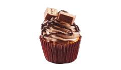 Close up of cupcake with a brown liner wrapper iced with chocolate whip, a fudge drizzle and a piece of a Coffee Crisp bar.