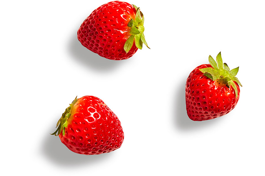 Fresh whole strawberries on a white background.
