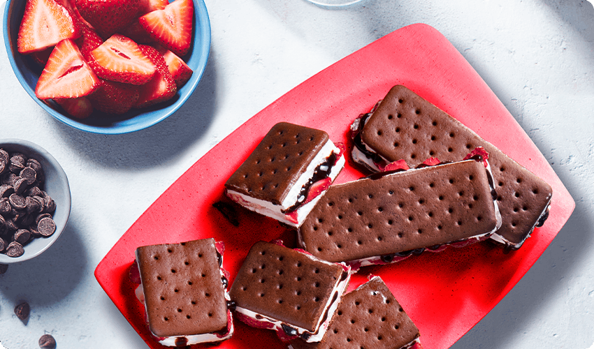 Red plate with stuffed ice cream sandwiches laid out on top