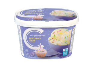 A purple tub of Compliments Birthday Cake Flavour Ice Cream with a photograph of a birthday cupcake with a candle in it on front.