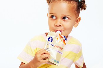 Young girl eating a Cerebelly bone broth puree
