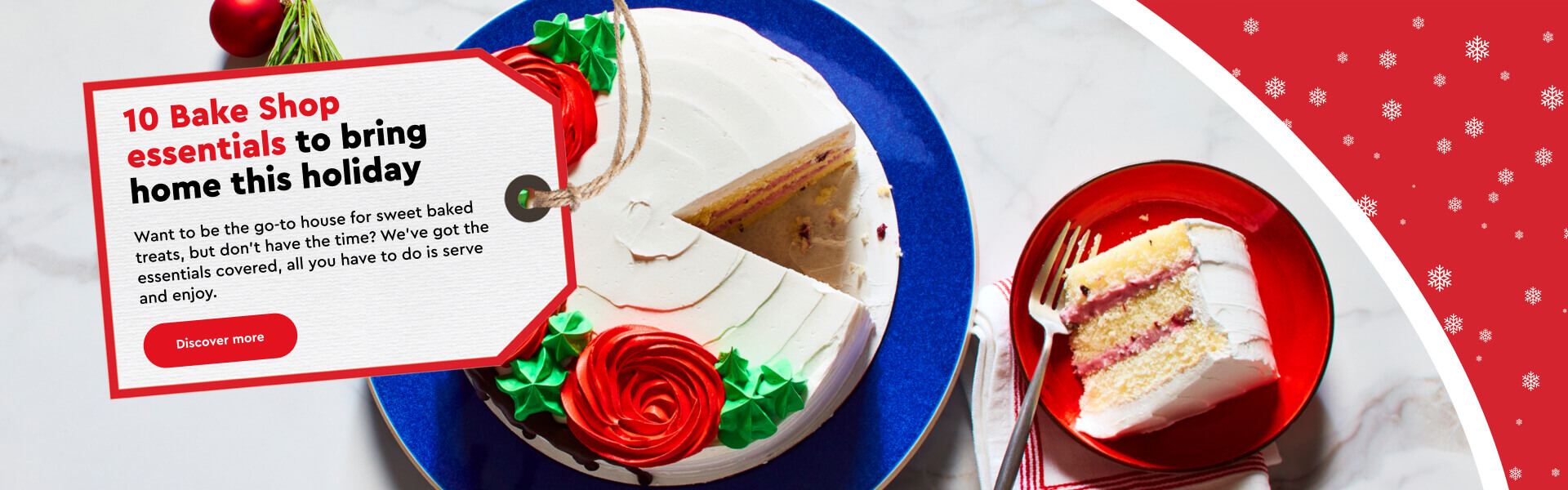 Round blue platter with Merry Berry Cake with white icing, green icing leaves and red icing roses on top