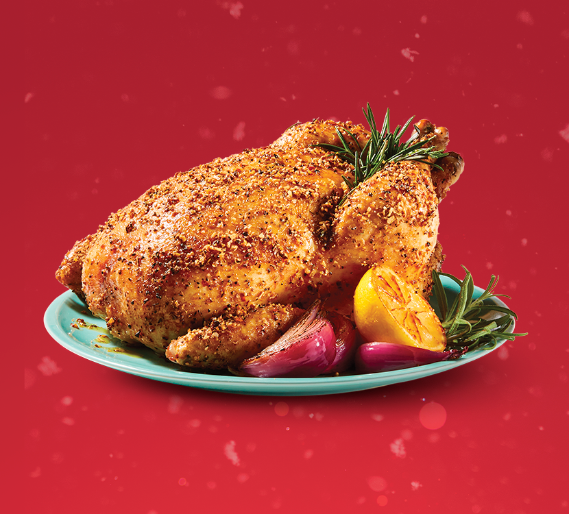 Homestyle seasoned chicken roast on red background